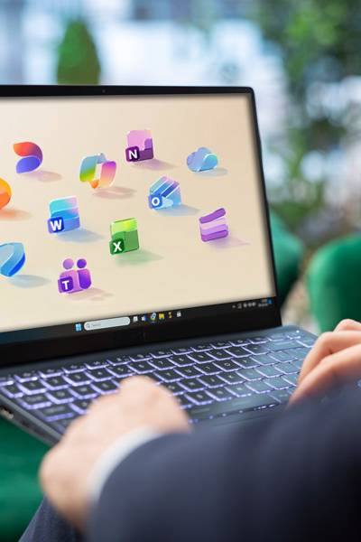 Microsoft 365 app icons above a laptop
